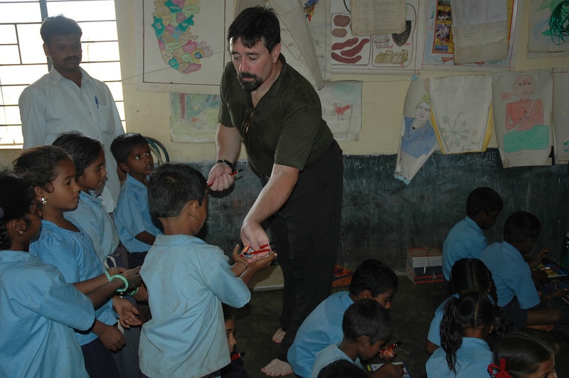 guest-distributing-pencils-at-guttepalaya-rural-school-l